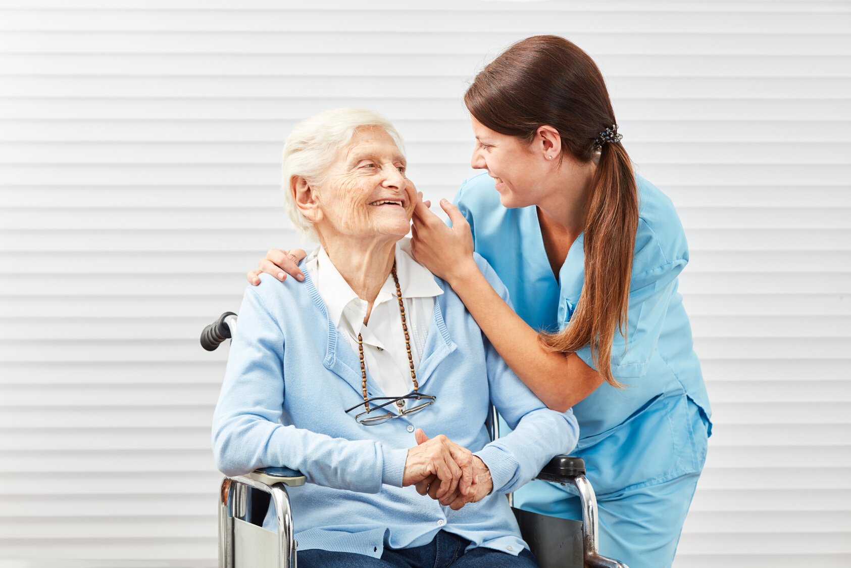 Nurse Taking Care of Senior Woman in Wheelchair