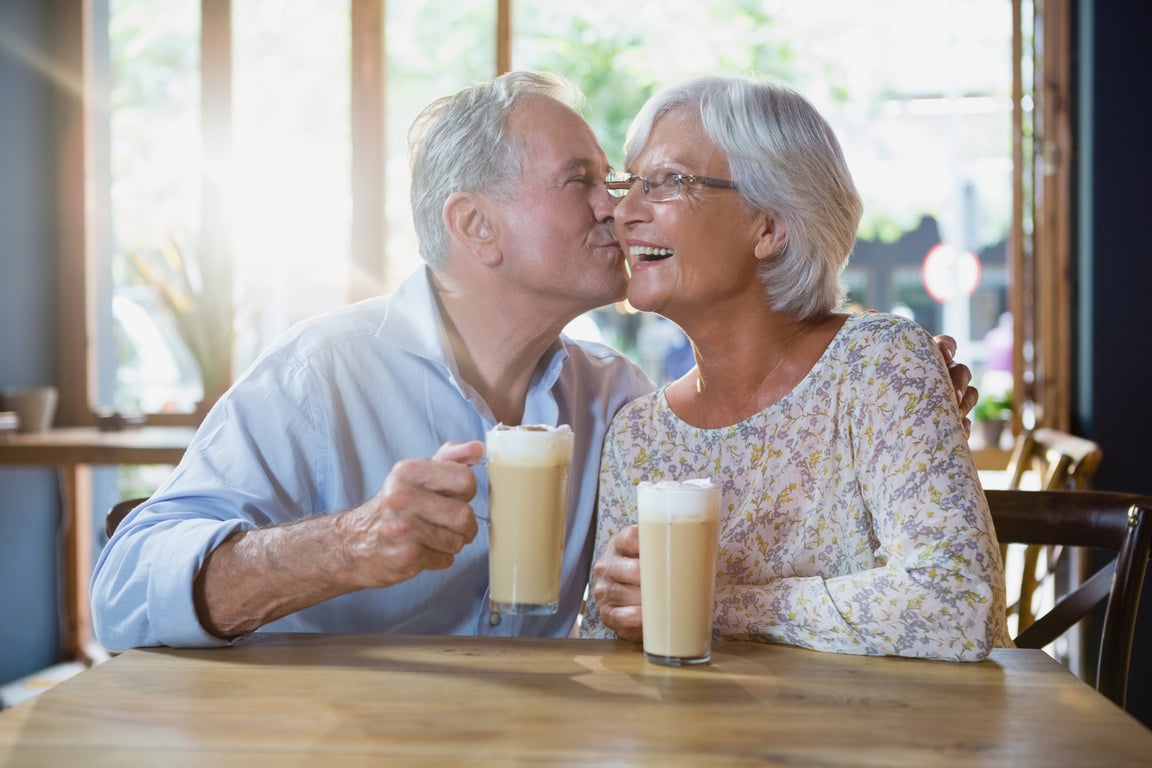 Senior man kissing senior woman